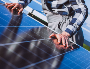 man worker firld by solar panels